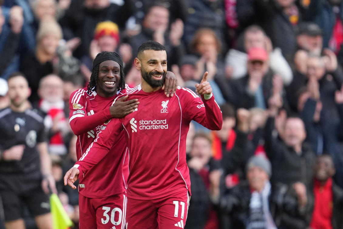 Liverpool’s Mohamed Salah celebrates with Jeremie Frimpong after scoring his side’s second goal during their English Premier League match against Fulham in Liverpool, Apr. 11, 2026. (AP)