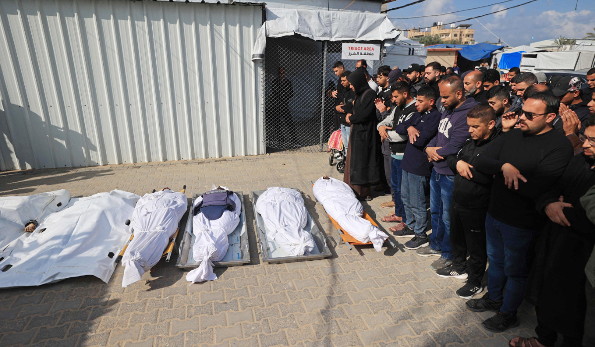 Mourners pray during the funeral of Palestinians, who according to medics were killed in an overnight Israeli strike, at Al-Aqsa Martyrs Hospital in Deir el-Balah, central Gaza Strip on April 11, 2026. (AFP)