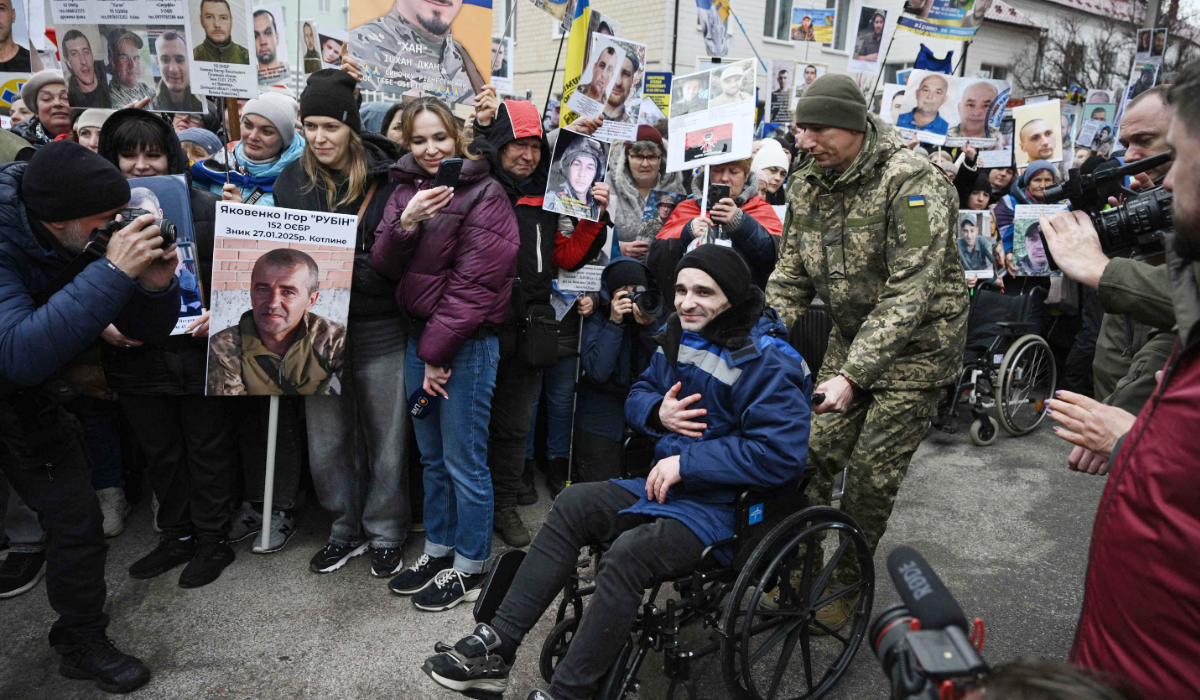 A released Ukrainian prisoner of war (POW) is pushed in a wheelchair after being swapped in a prisoner exchange in the Chernihiv region on April 11, 2026, amid the Russian invasion of Ukraine. (AFP)
