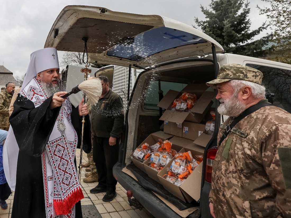 Metropolitan Epiphanius I, head of the Orthodox Church of Ukraine, sprinkles holy water on a Ukrainian serviceman at St Michael's Cathedral before Orthodox Easter, in Kyiv, Ukraine. (Reuters)