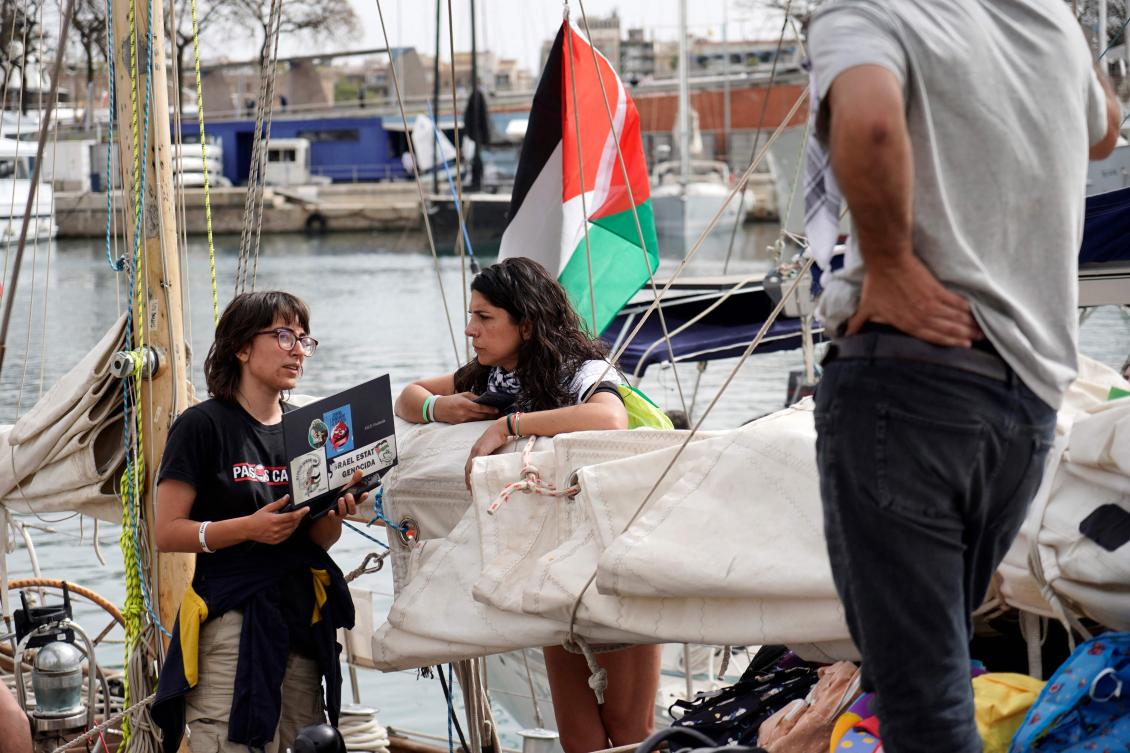 Pro-Palestinian activists speak on board a boat on the eve of the departure of a new humanitarian flotilla bound for the Gaza Strip, in Barcelona, on April 11, 2026. (AFP)