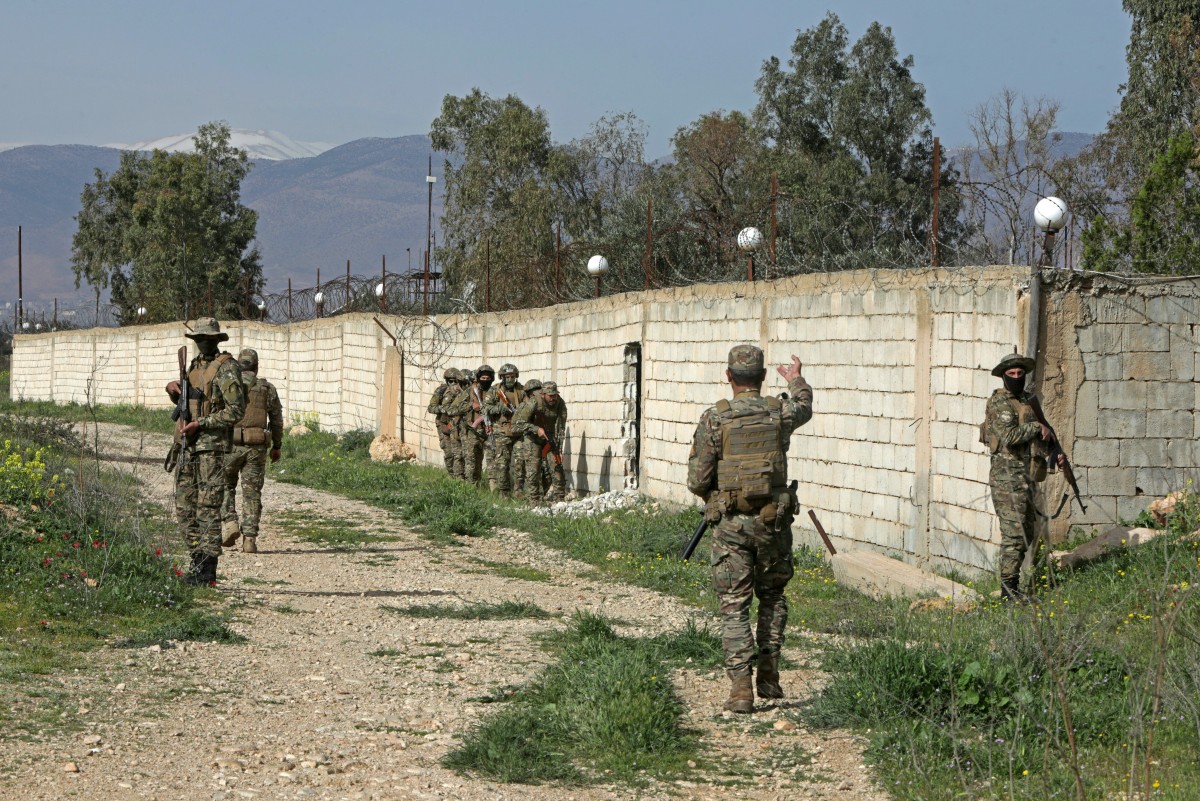 Syrian army soldiers patrol along the Syrian–Lebanese border in the rural area of Al Qusayr. (AFP)