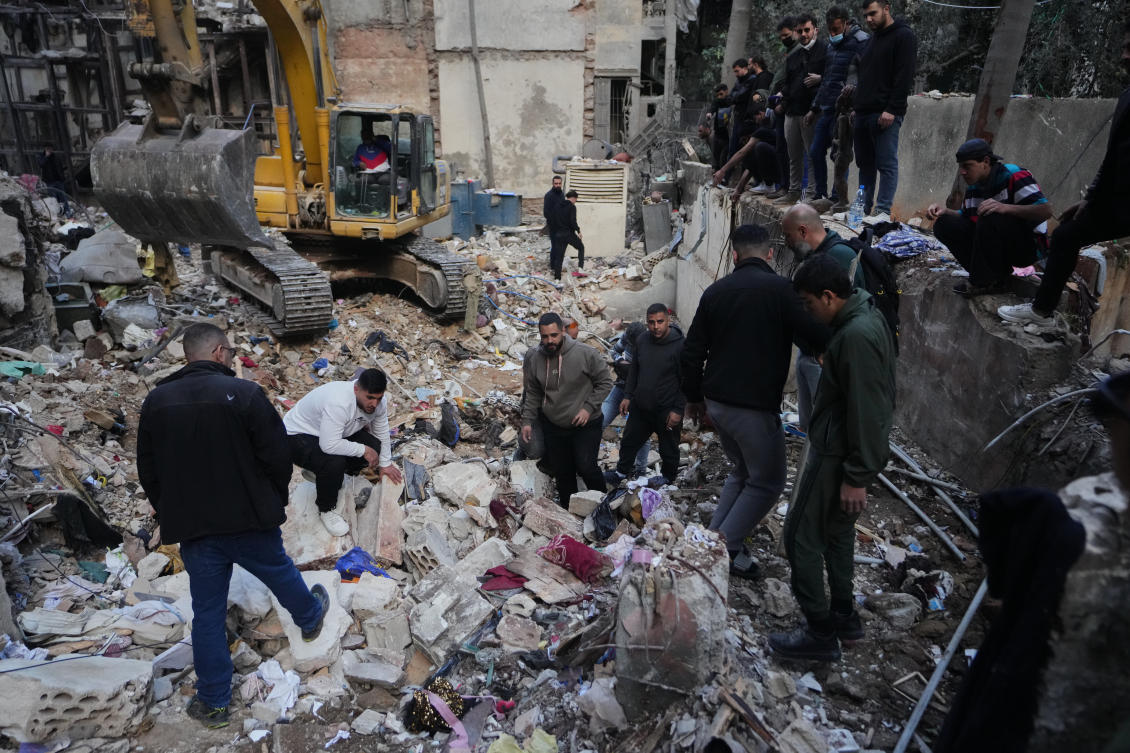 Civilians and rescue workers search through rubble at the site of a building where efforts continue to recover the body of a missing woman after it was destroyed in an Israeli airstrike on Wednesday, in central Beirut, Sunday, April 12, 2026. (AP)