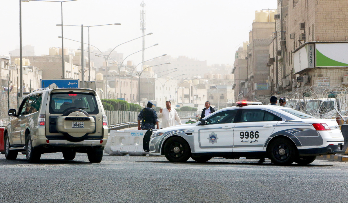 Kuwaiti police officers man a checkpoint at the entrance the town of Jeleeb Al-Shuyoukh, south the capital Kuwait City. (AFP file photo)