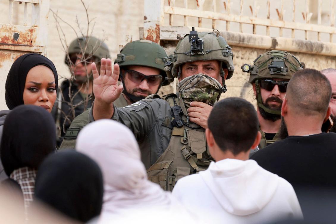 An Israeli soldier confronts Palestinian residents of the Jenin refugee camp, which has been closed off since the start of Israel’s military “Operation Iron Wall” in January 2025. (AFP)