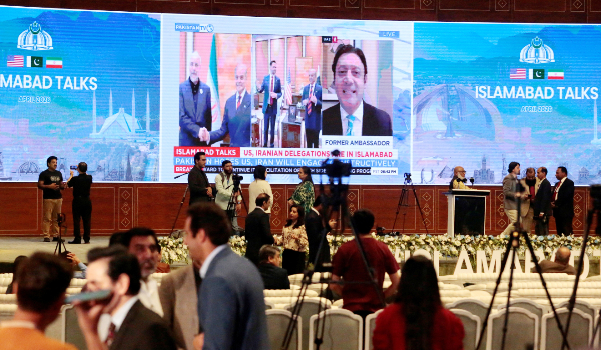 Members of the media work as a screen displays news with images of Pakistan's Prime Minister Shehbaz Sharif meeting with US Vice President JD Vance and separately with Iranian Parliament Speaker Mohammad Bagher Ghalibaf in Islamabad, Pakistan, April 11, 2026. (REUTERS)