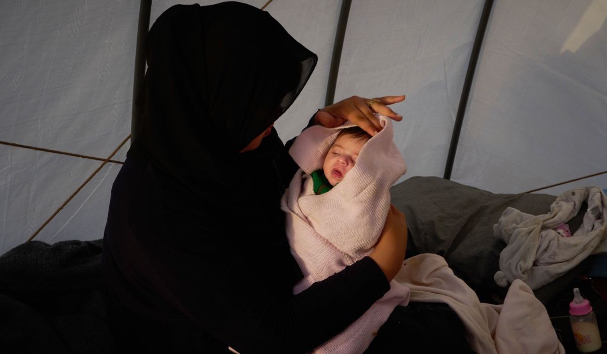 Haifa Kenjo, who fled Israeli airstrikes on the southern suburbs of Beirut, holds her 15-day-old daughter Shiman inside the tent she uses as a shelter and where she gave birth to her in Beirut, Sunday, April 12, 2026. (AP)