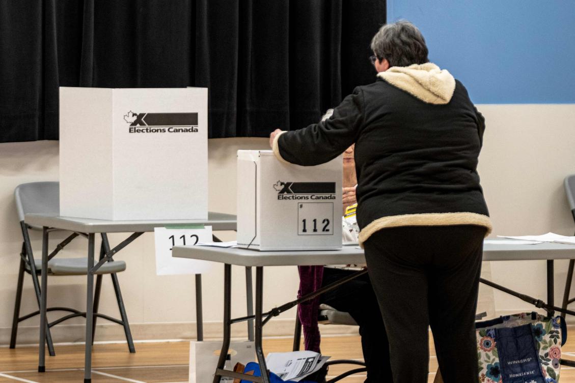 Above, a person casts his vote at a polling station in Terrebonne, Quebec, Canada on April 13, 2026. (AFP)