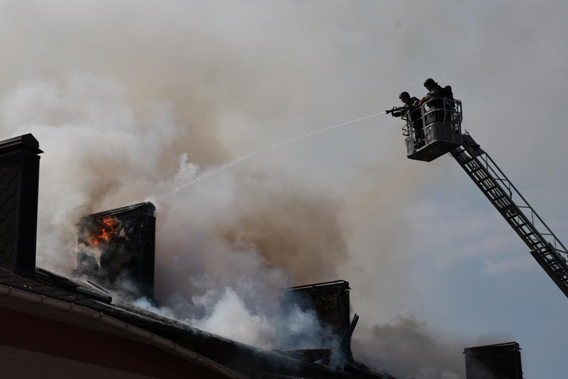 Rescue workers try to put out a fire of a building burning after a Russian drone attack on Zaporizhzhia, Ukraine, Apr. 13, 2026. (AP)