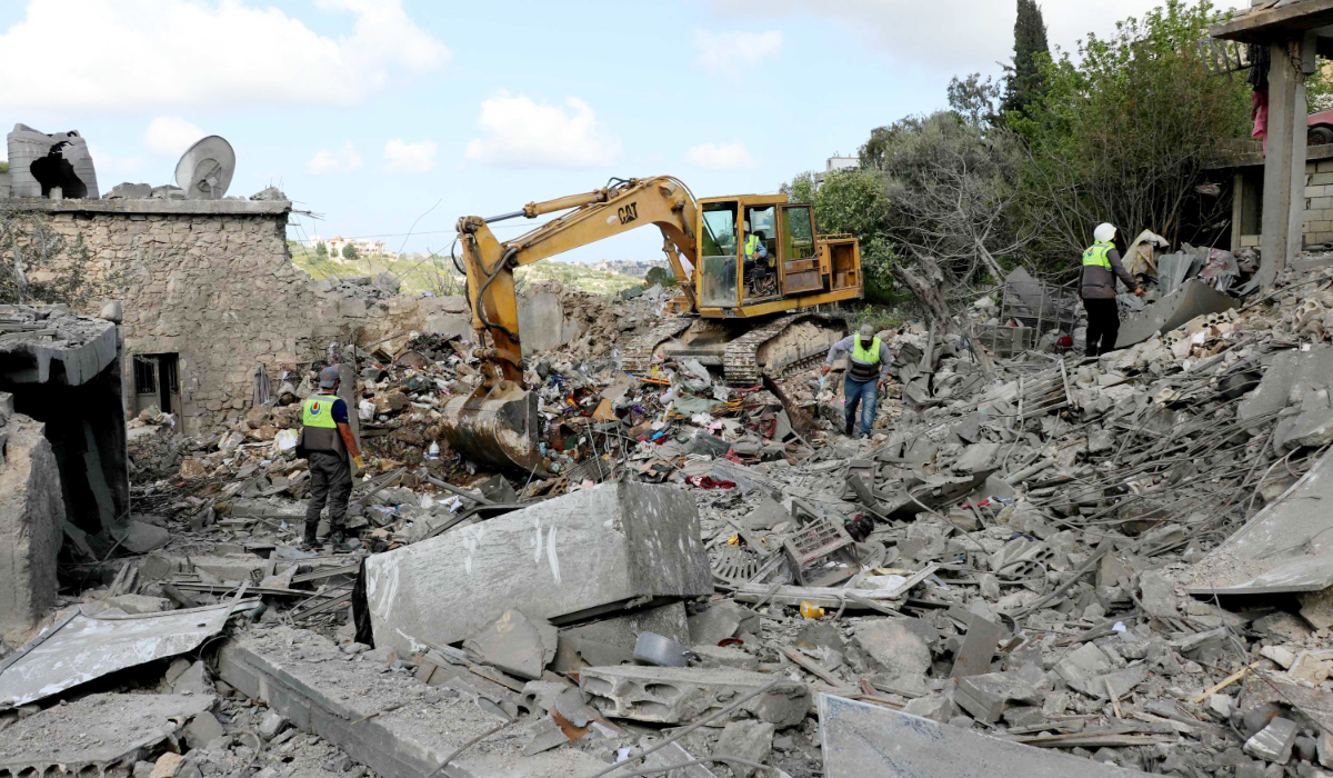 Lebanese first responders search for survivors in the aftermath of an Israeli airstrike that targeted the southern Lebanese village of Maaroub on April 13, 2016. (AFP)