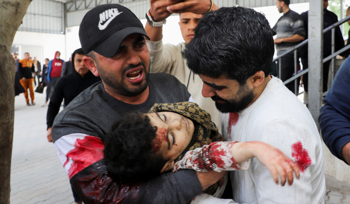 Palestinians carry the body of three‑year‑old Yahya Al‑Malahi, who was killed in an Israeli strike, according to medics, in Gaza City, April 14, 2026. (REUTERS)