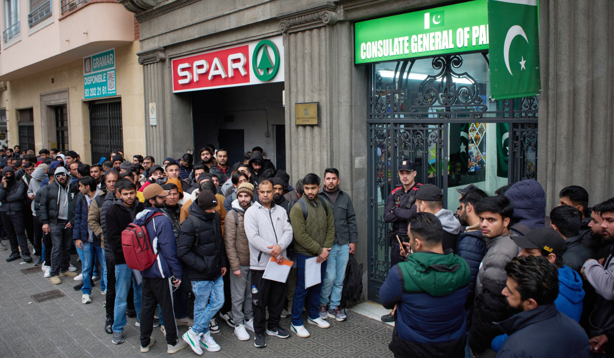 A crowd of Pakistanis gather at the entrance of the Pakistani consulate in Barcelona, Spain, Thursday, Jan. 29, 2026, following the Spanish government's decision to grant residency and work permits to potentially hundreds of thousands of immigrants. (AP)