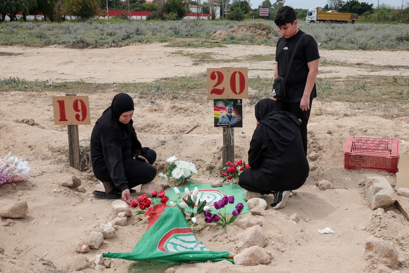 A family mourns their relative at a temporary graveyard in Tyre, south Lebanon, April 15, 2026. (Reuters)