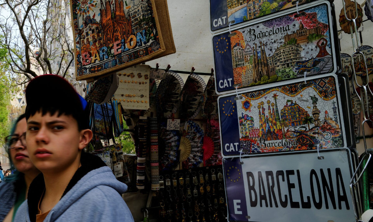 Tourists walk past a souvenir shop near the Sagrada Familia basilica during Holy Week in Barcelona, Spain, April 2, 2026. (Reuters)