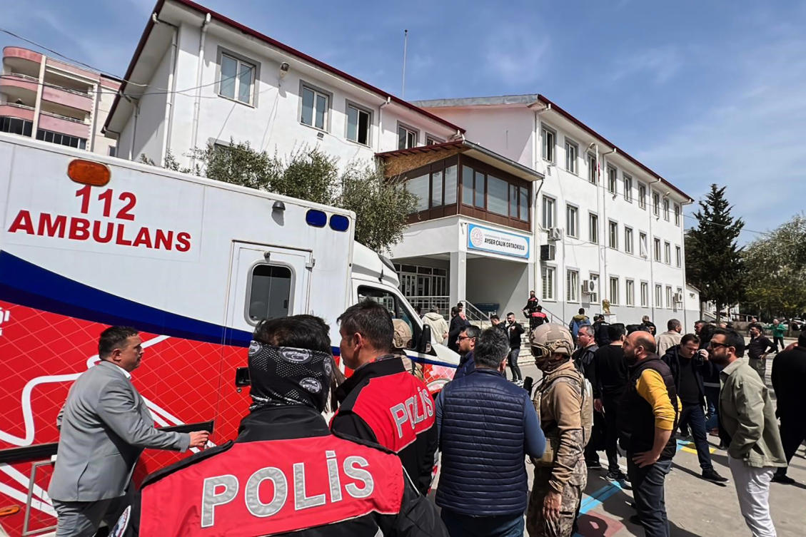 Turkish security forces and emergency staff stand in the courtyard of a secondary school where an assailant opened fire, in Kahramanmaras, Turkey, Wednesday, April 15, 2026, (AP)