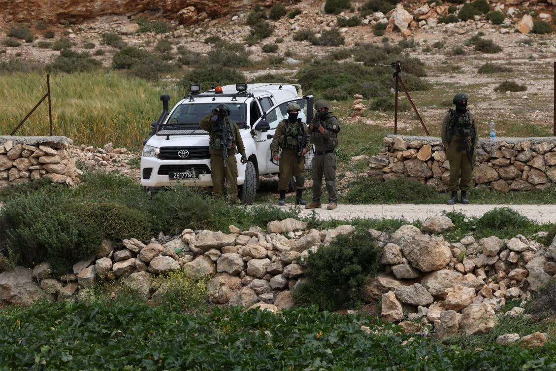 Israeli security personnel stand guard near the demolition site of a Palestinian workshop that was reportedly built without an Israeli permit, in Beit Ula village near the occupied West Bank city of Hebron on Apr. 15, 2026. (AFP)