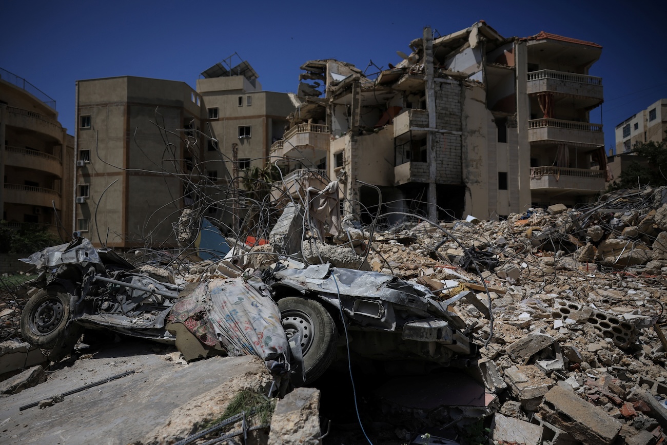 A damaged building, rubble and a destroyed vehicle in the aftermath of Israeli strikes, near Hiram Hospital in Tyre, south Lebanon, April 16, 2026. (Reuters)