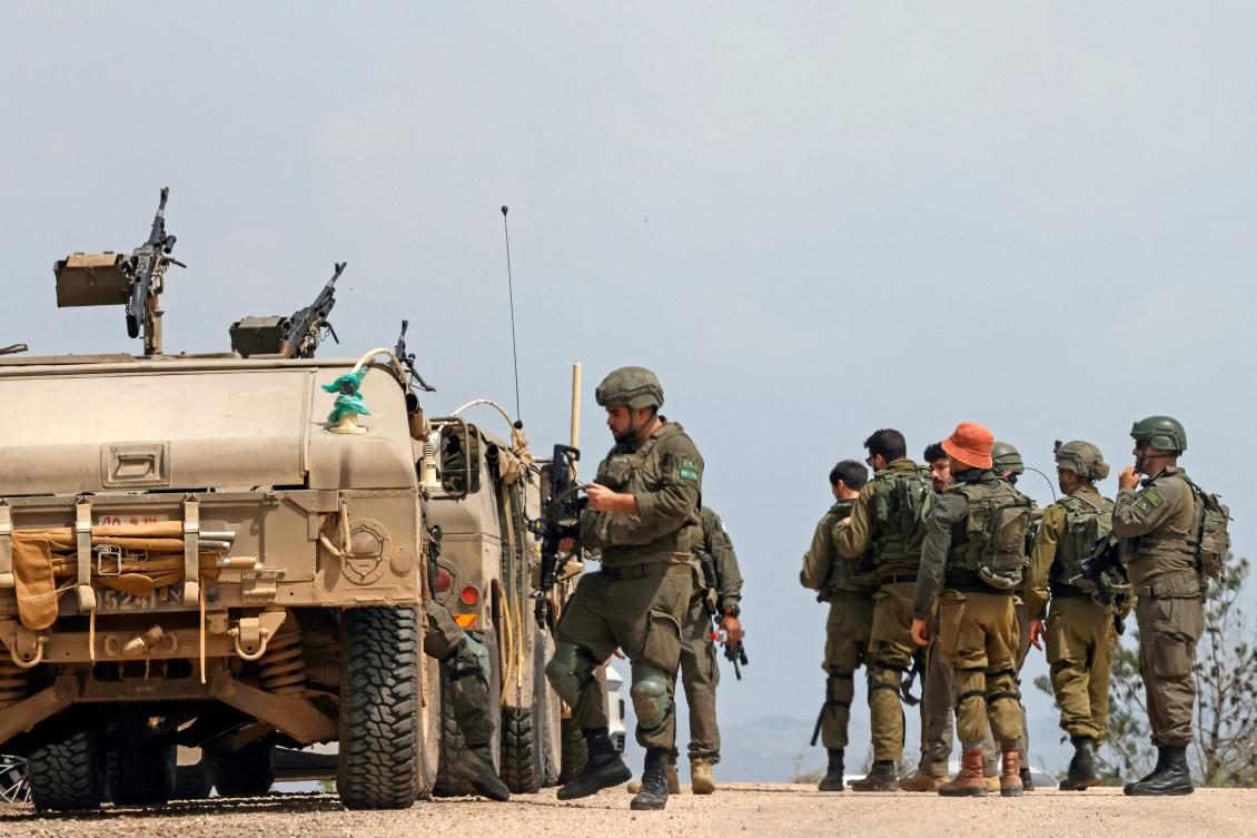 Israeli army soldiers stand next to their humvees as they patrol along the border with southern Lebanon, in the Upper Galilee of northern Israel on Apr. 17, 2026. (AFP)