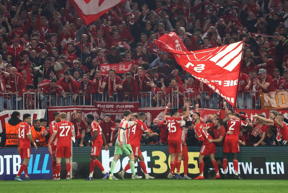 Fans enter the Photographers zone to celebrate with the Bayern Munich team after the UEFA Champions League quarter-final second leg match against Real Madrid in Munich, on Apr. 15, 2026. (AFP)