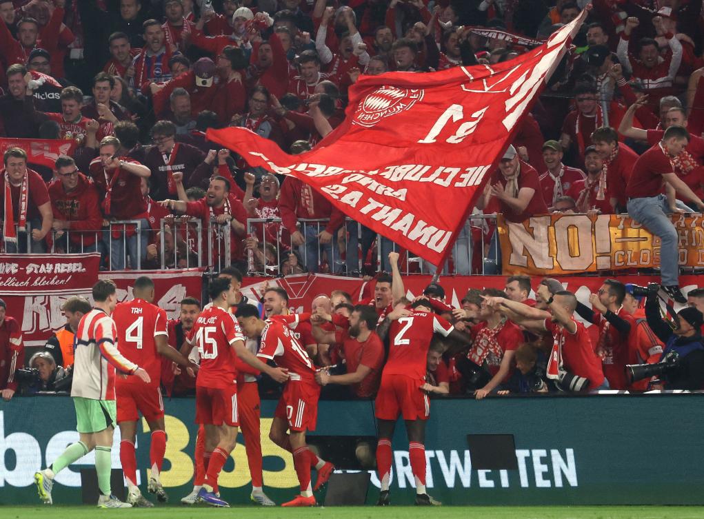 Fans enter the Photographers zone to celebrate with the Bayern Munich team after the UEFA Champions League quarter-final second leg match against Real Madrid in Munich, on Apr. 15, 2026. (AFP)