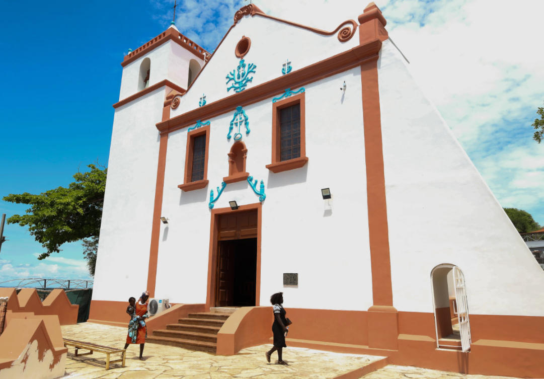 People walk by the Church of Our Lady of Muxima in Muxima, Angola, on April 11, 2026, which Pope Leo XIV will visit during his 11-day pastoral visit to Africa. (AP Photo)
