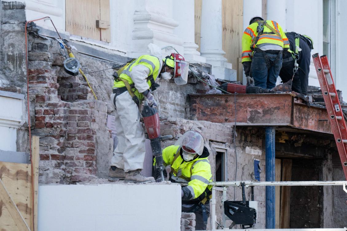 Construction workers demolish what is remaining of the East Wing of the White House alongside the main Residence as demolition continues in preparation to build a new ballroom for the White House in Washington, DC on Dec. 1, 2025. (AFP)