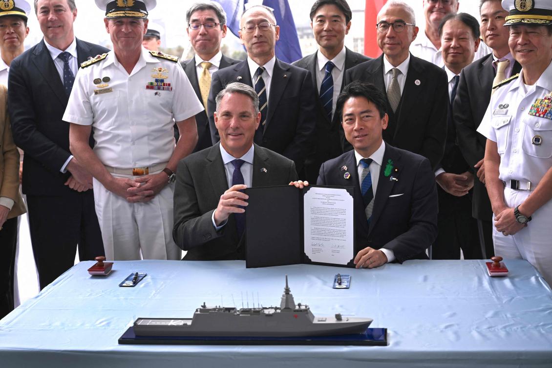 Australia's Deputy Prime Minister and Minister for Defence Richard Marles (front L) and Japan's Minister of Defense Koizumi Shinjiro (front R) pose for a photo after the signing of the contract for Japan to deliver the first three of Mogami-class warships, in Melbourne on April 18, 2026. (AFP)