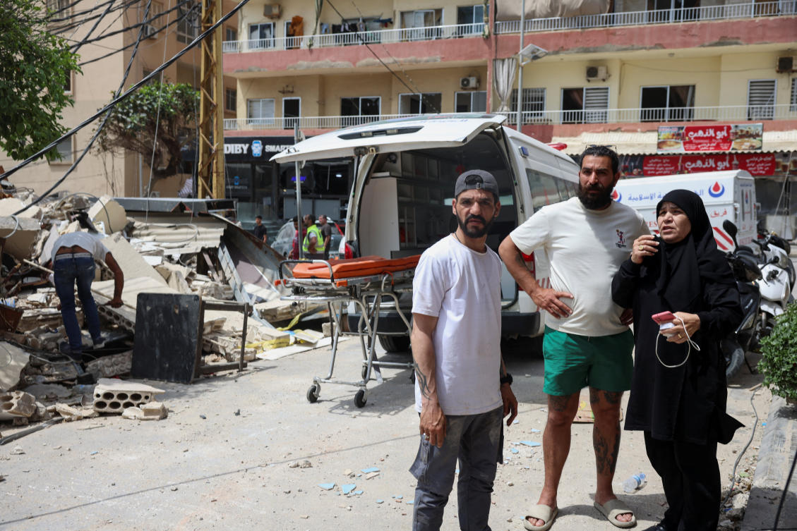 People gather at the site of an Israeli strike carried out before a 10-day ceasefire between Lebanon and Israel went into effect, in Tyre, Apr. 17, 2026. (Reuters)