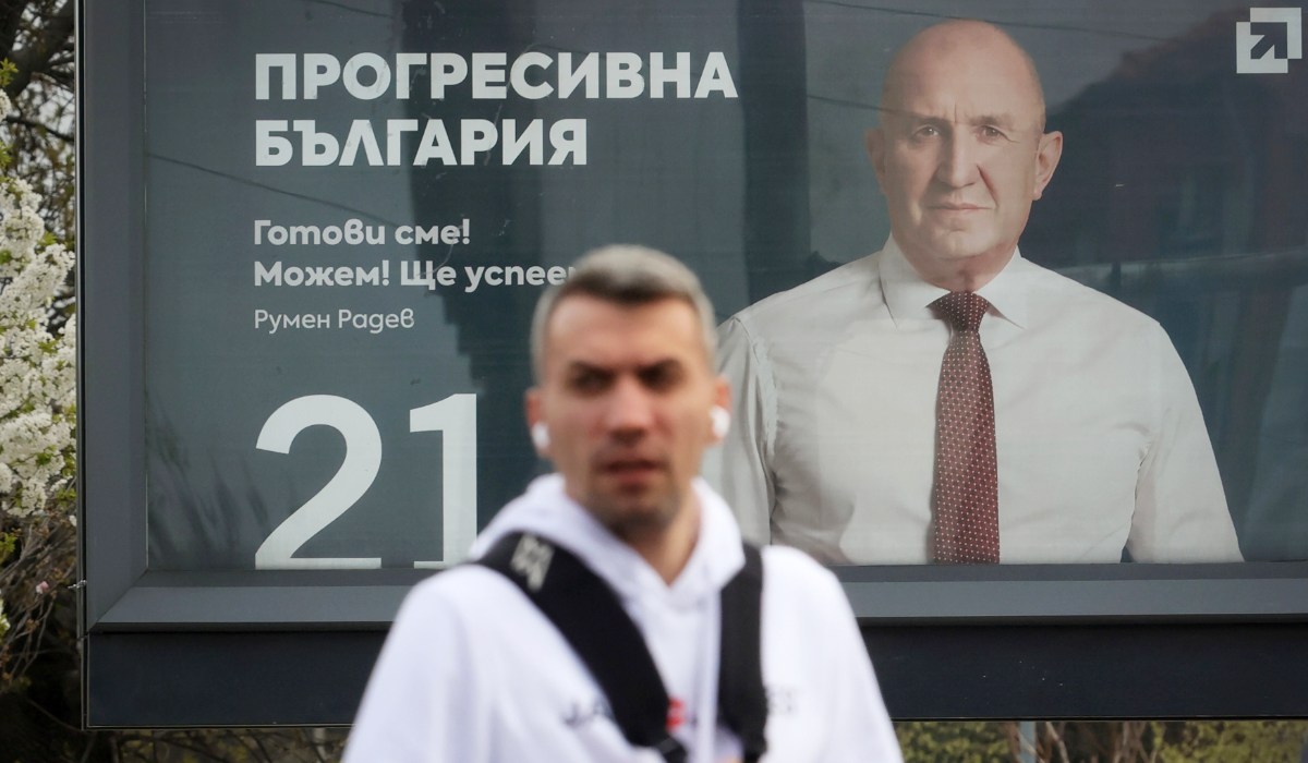 An election poster of former Bulgarian President Rumen Radev is seen in Sofia, as a man passes in front on Thursday, April 16, 2026, with Bulgaria heading into an early parliamentary election. (AP)