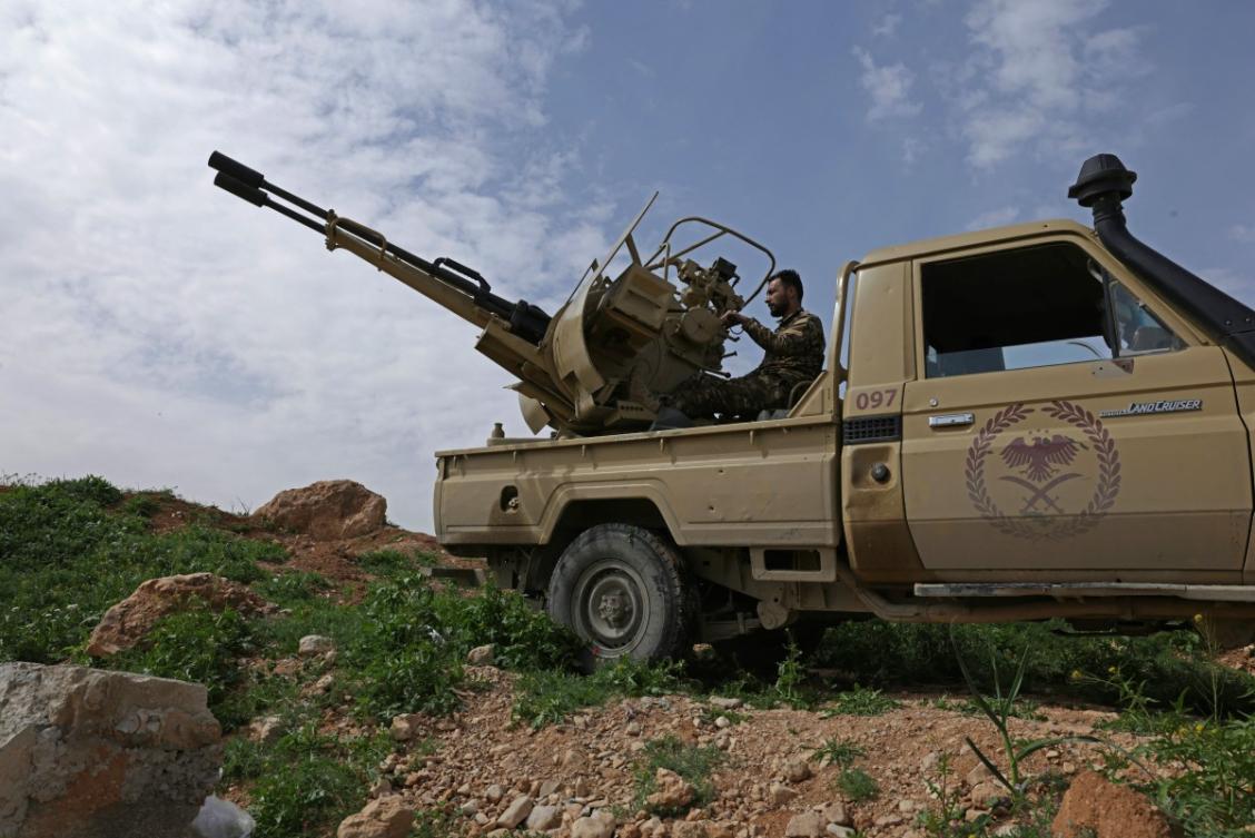 A Syrian army soldier operates an armoured vehicle positioned along the Syrian–Lebanese border in the rural area of Al Qusayr on April 1, 2026. (AFP)