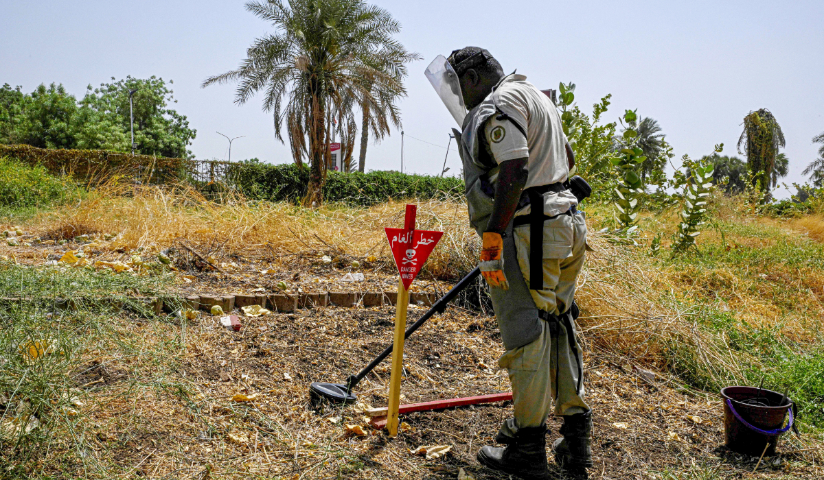 A member of the Danish Refugee Council and Jasmar Human Security Organization sweeps a metal detector as he searches for land mines in Al-Mugran Park in Khartoum on April 19, 2026. (AFP)