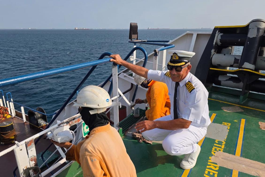 Captain Rahman Al-Jubouri, right, supervises sailors on the deck of the Sea Moon oil tanker on the waters the Gulf of Oman, April 15, 2026. (Photo courtesy of Capt. Rahman Al-Jubouri via AP)