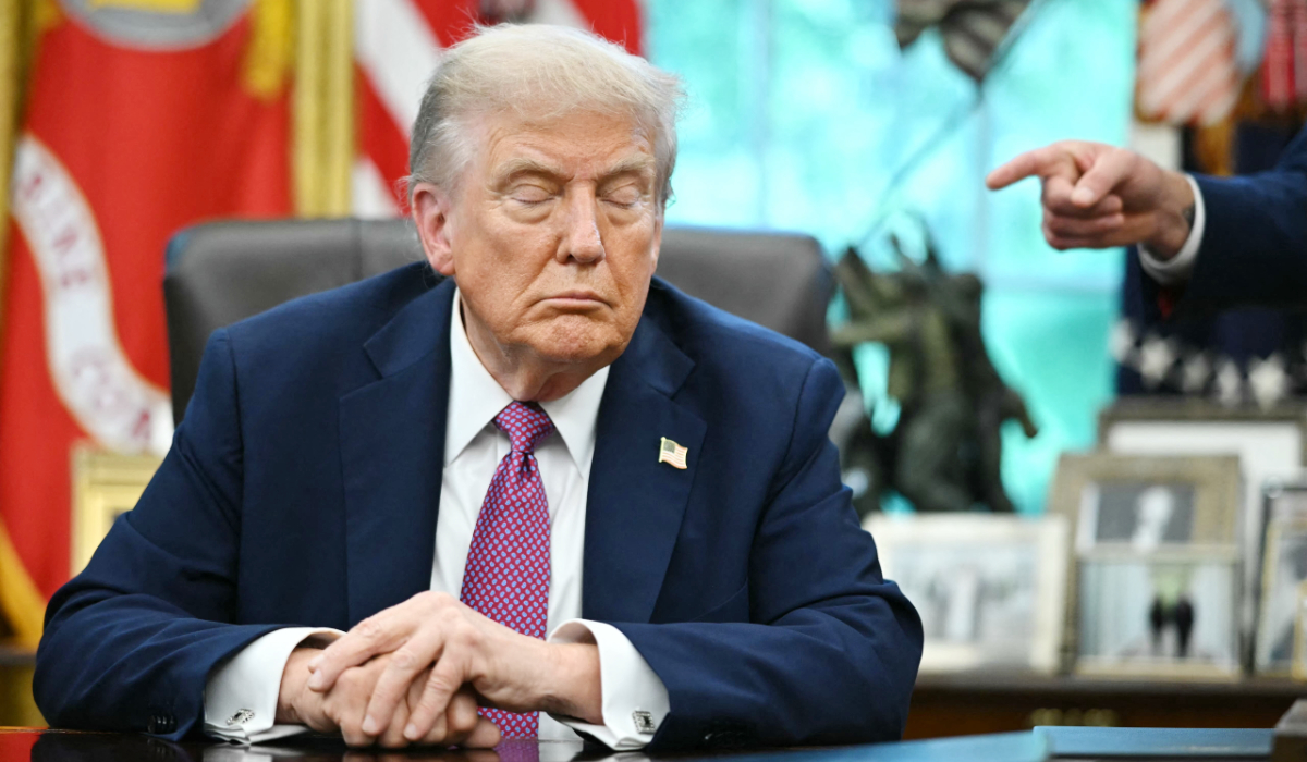 US President Donald Trump reacts as the Secretary of Defense Pete Hegseth points at him after signing executive orders in the Oval Office of the White House in Washington, DC on September 5, 2025. (AFP)
