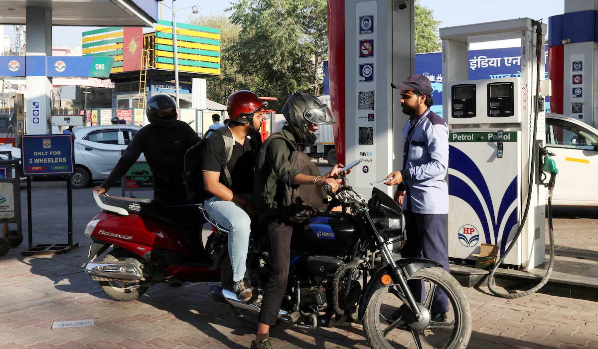 A man pays after refuelling his bike at a fuel station in New Delhi, the capital city of India. (Reuters)