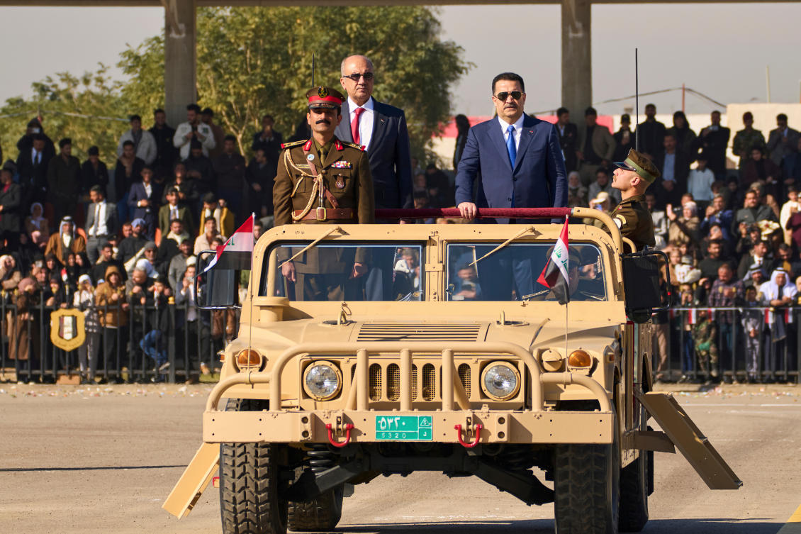 Iraqi Prime Minister Mohammed Shia al-Sudani, right, rides in a Humvee during the Army Day celebrations, in Baghdad, Iraq, Tuesday, Jan. 6, 2026. (AP Photo/Hadi Mizban, File)