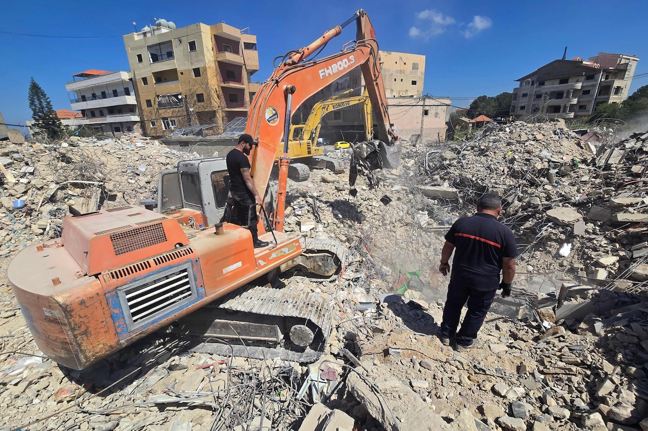 Diggers are used by rescue teams to remove rubble from a building previously hit by the Israeli army, in southern Lebanese village of Hanaouay on April 22, 2026. (AFP)