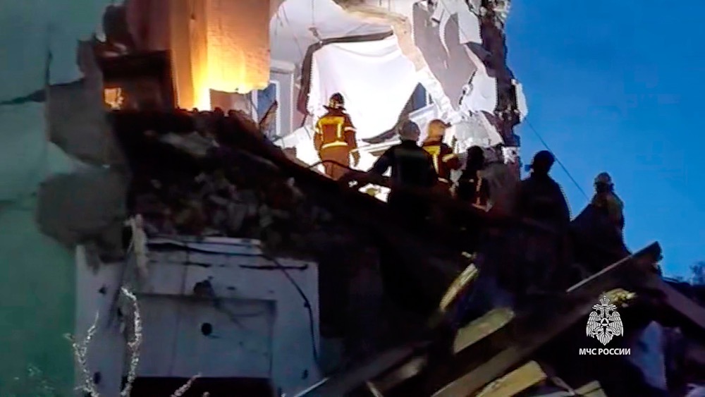 Russian Emergency Ministry employees work at the side of the damaged multi-storey apartment building hit by a Ukrainian drone in Syzran in Russia’s Samara Region Wednesday, April 22, 2026. (Russian Emergency Ministry Press Service via AP)