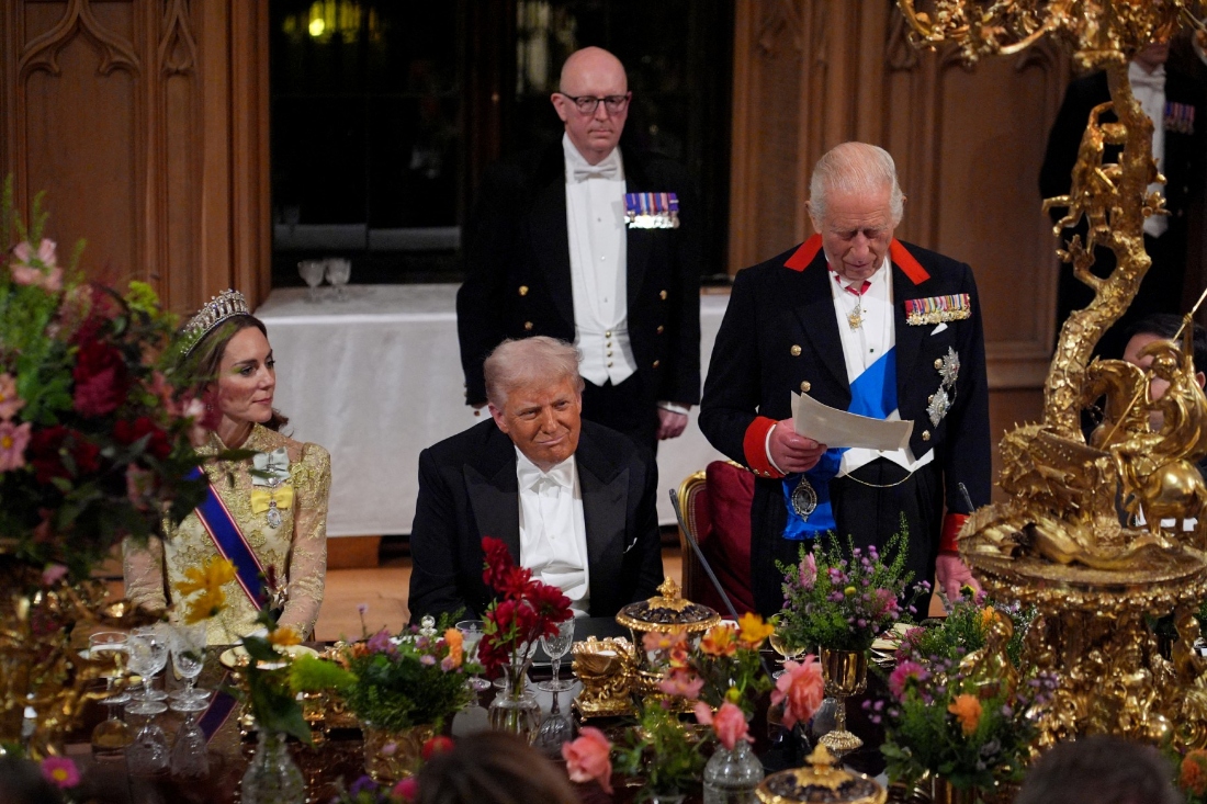 US President Donald Trump reacts as Britain's King Charles III delivers a speech during a State Banquet at Windsor Castle, in Windsor, on September 17, 2025, during the US President's second State Visit. (AFP)
