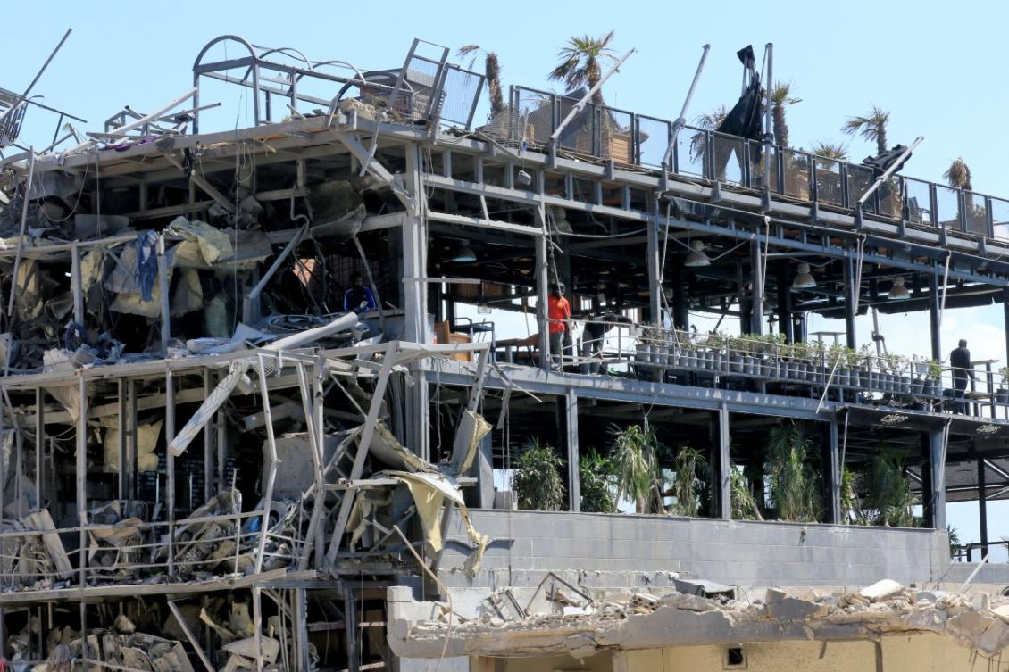 Above, people inspect the damage inside a building destroyed in Israeli strikes in the southern Lebanese coastal city of Tyre on April 21, 2026. (AFP)