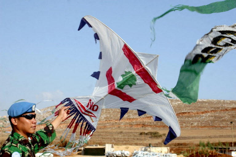 Above, an Indonesian soldier serving with the United Nations Interim Forces in Lebanon flies a kite with a Lebanese flag painted on it. (AFP file photo)