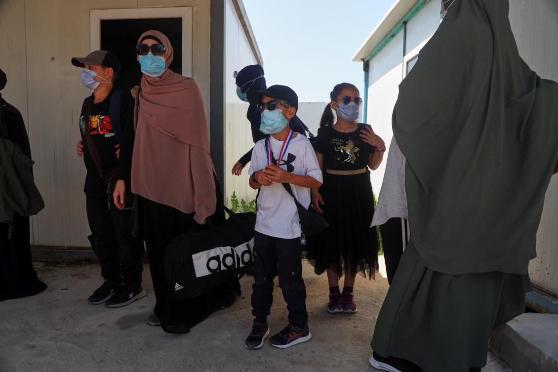 Members of Australian families at Roj Camp in eastern Syria, housing people with alleged ties to Daesh militants, prepare to leave for Damascus as part of a second repatriation effort by Syrian authorities on April 24, 2026. (AP)