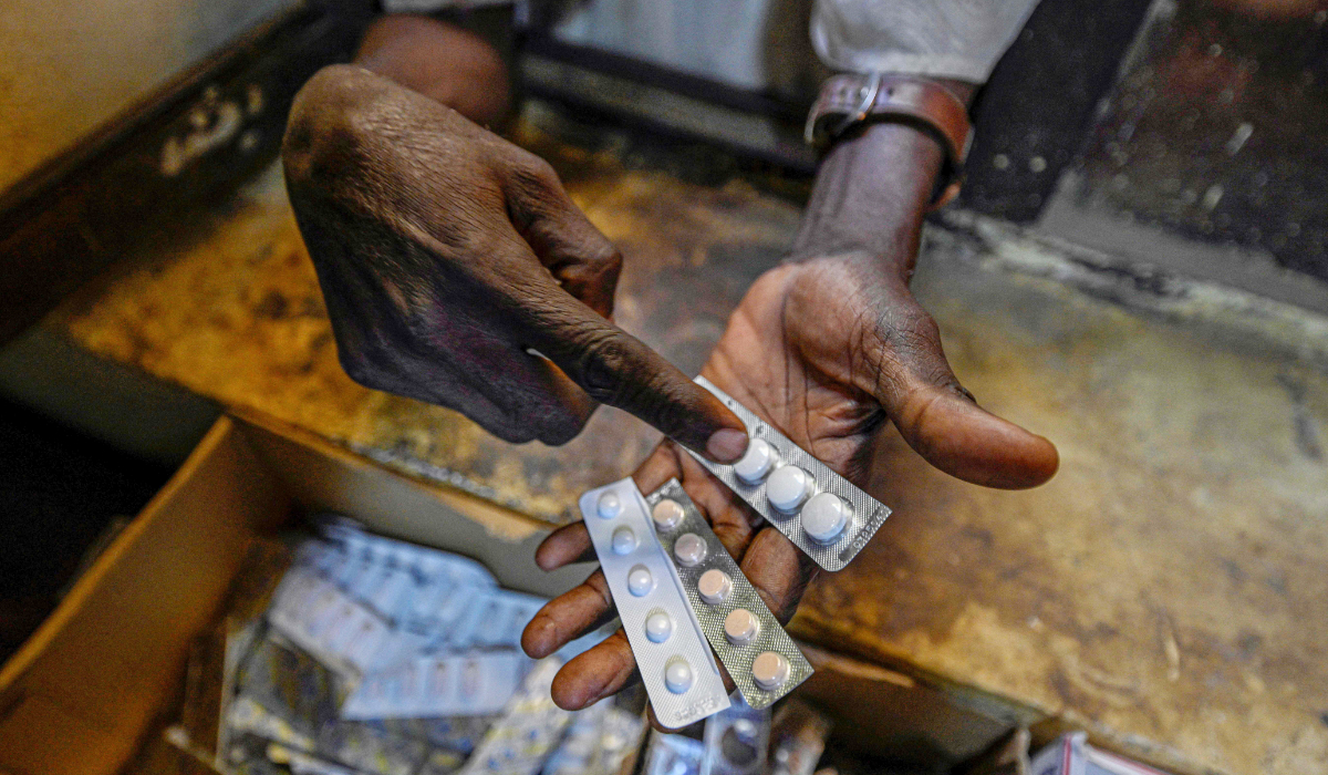 This photo taken on April 18, 2026 shows Sudanese people receiving free medicine provided by volunteers at Omdurman's Al-Nao Educational Hospital, the capital's main functioning health facility. (AFP)
