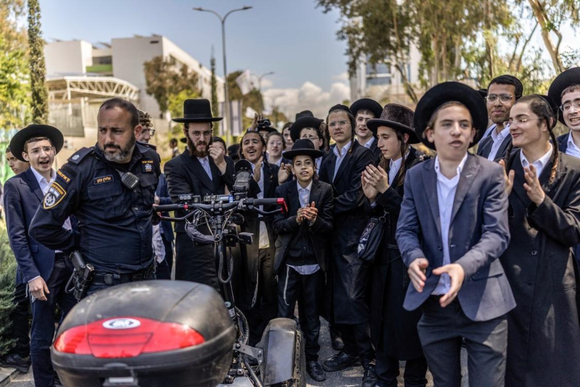 Ultra-Orthodox Jews, who are largely exempt from military service, protest against conscription at the entrance to Tel Hashomer, the central recruitment centre of the Israeli Army, in Ramat-Gan on April 12, 2026. (AFP)