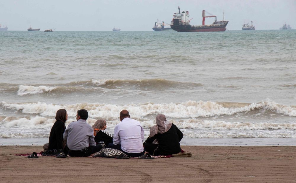In this picture obtained from Iran’s ISNA news agency on April 24, 2026, Iranians are seen at Suru Beach in Bandar Abbas along the Strait of Hormuz. (AFP)