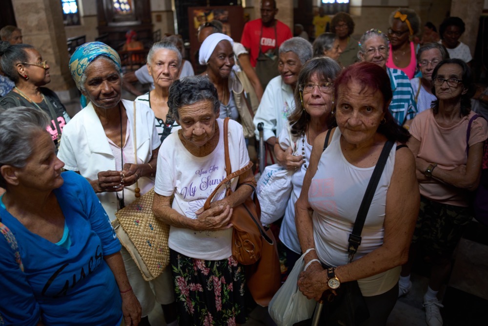 Elderly residents wait to be served a free meal in a dining hall adjacent to Church of the Holy Spirit where seniors gather three times a week for a free meal, in Old Havana, Cuba. (AP)