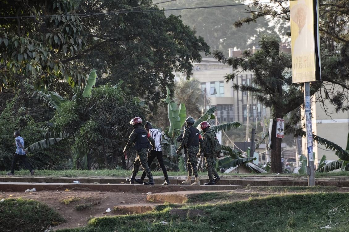 Ugandan military police officers detain a voter on the ground near a polling station in Kampala on January 15, 2026, during Uganda's 2026 general elections. (FILE/AFP)