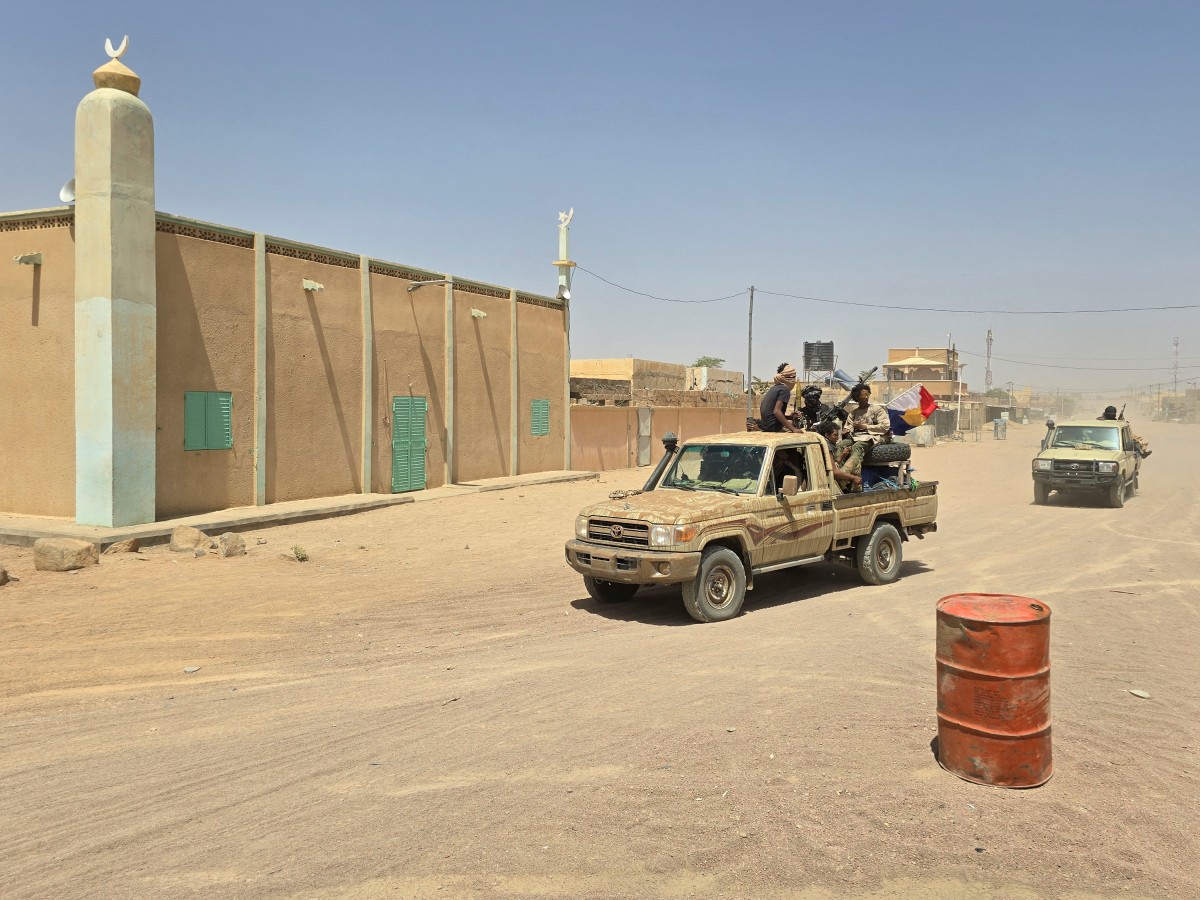Tuareg rebels of the Azawad Liberation Front (FLA) coalition ride on the back of a pickup truck in Kidal, Mali. (AFP)
