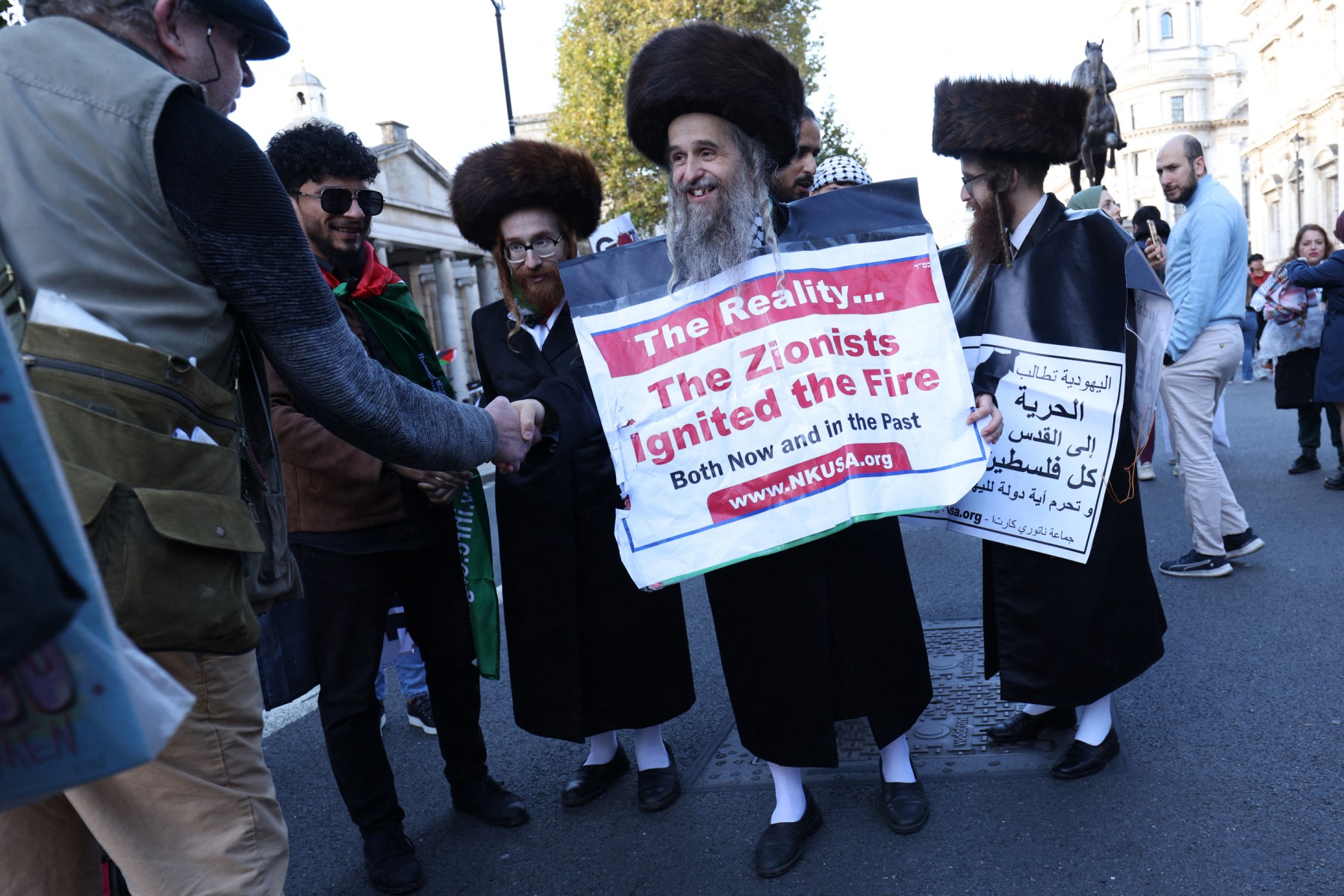 Protesters from the Orthodox Jews Against Zionism movement shake hands with other attendees after a 'March For Palestine', part of a pro-Palestinian national demonstration, in London on October 14, 2023. (File/AFP)