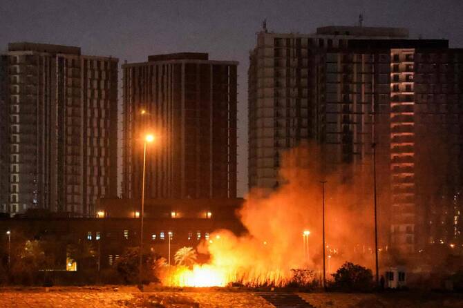 Fire burning on the grounds of the US Embassy in Baghdad’s fortified Green Zone last month. Air defenses fired at a drone in the same area on Tuesday. (AFP/File)