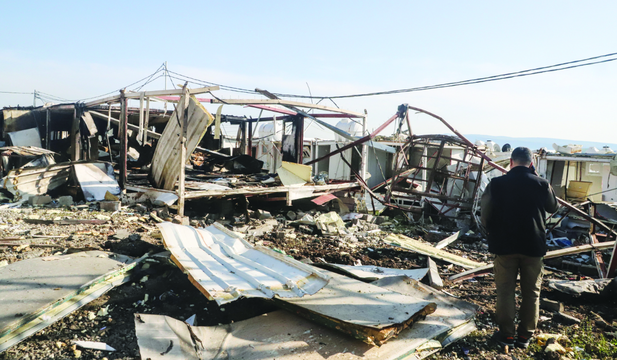 A Komala party member looks at the remains of the mangled structures following drone strikes on the Iranian Kurdish opposition Komala party's Sordash camp in Sulaymaniyah in the autonomous Kurdistan region on April 15, 2026. (AFP)